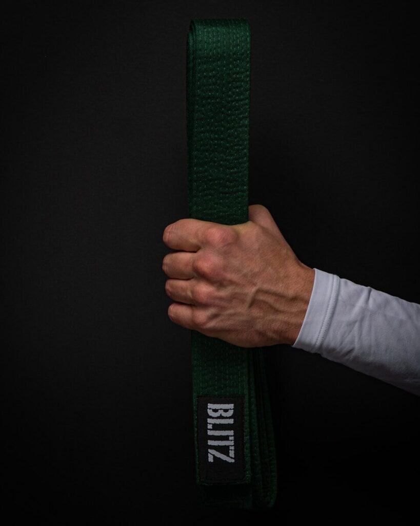 person holding green and black strap