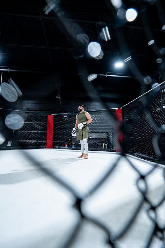 A man standing in the middle of a boxing ring
