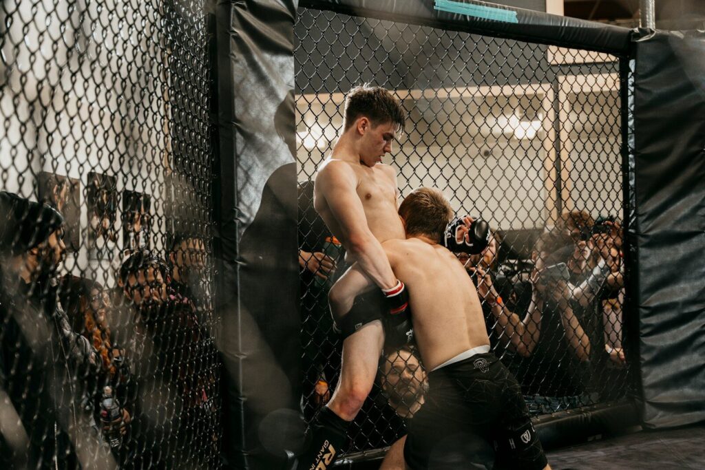 a couple of men standing next to each other in a cage